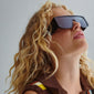 Johari sunglasses black on a woman, showcasing oversized frames and broad temples, embodying trendy L.A. style with sustainable design and UV protection.