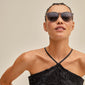 VANILLE sunglasses grey/gold: Woman wearing stylish dark grey sunglasses with golden temples, embodying minimalist elegance and UV protection from Pilgrim.