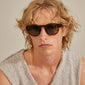 Man wearing sunglasses with the PAOLA chain for sunglasses, gold-plated, showcasing its delicate, stylish design, perfect for trendy, layered styling.