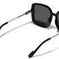 ALIET sunglasses black/gold from Pilgrim, featuring oversized black lenses for a vintage-inspired look, offering UVA/UVB protection and accompanied by a sustainable pouch.