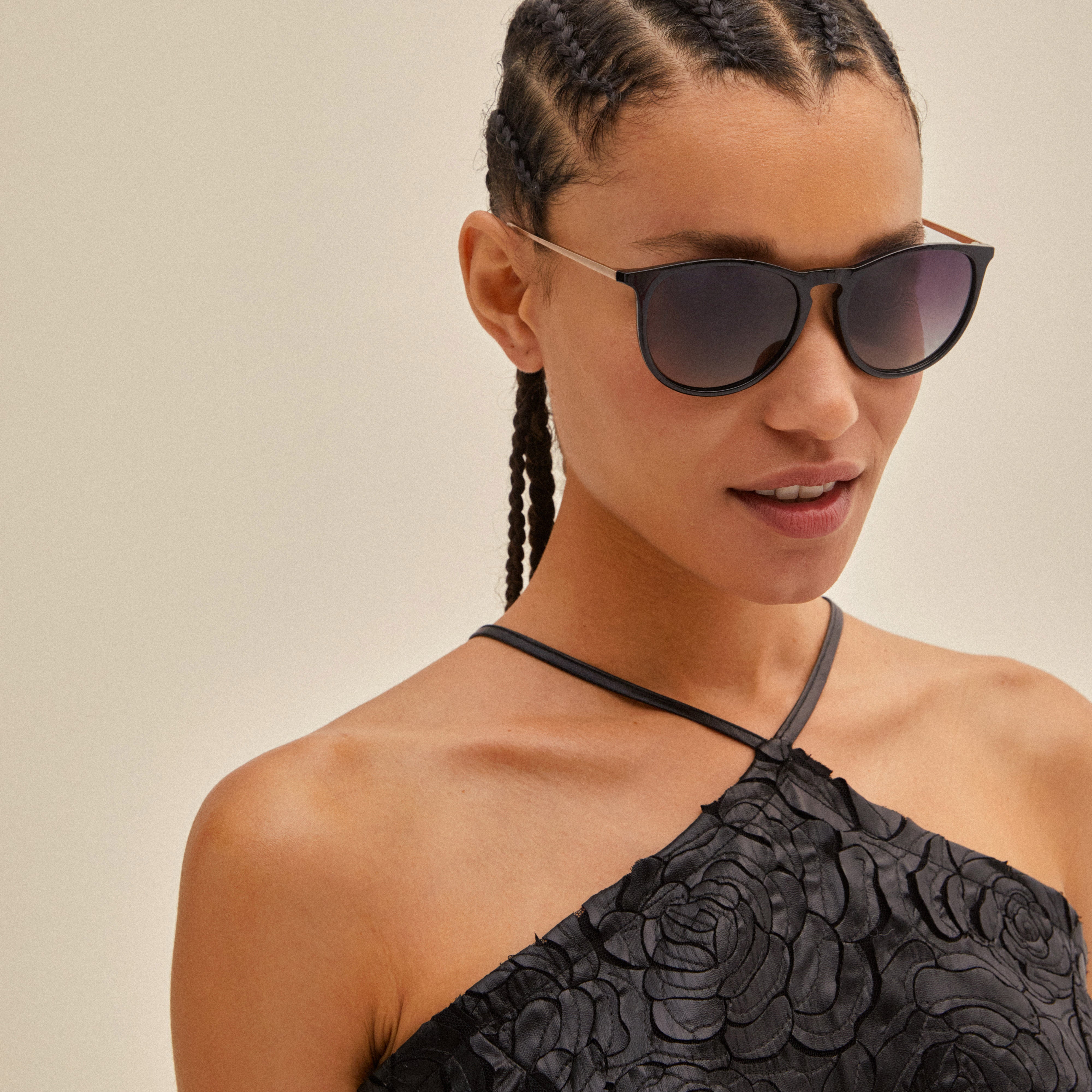Woman wearing VANILLE sunglasses with stylish metal temples and soft rounded lenses, showcasing a chic, versatile accessory from Pilgrim.