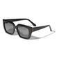 JOGLI sunglasses black/gold, featuring oversized black frames with golden hinge details, made from recycled acetate, offer stylish UV protection. Comes with a sustainable pouch.