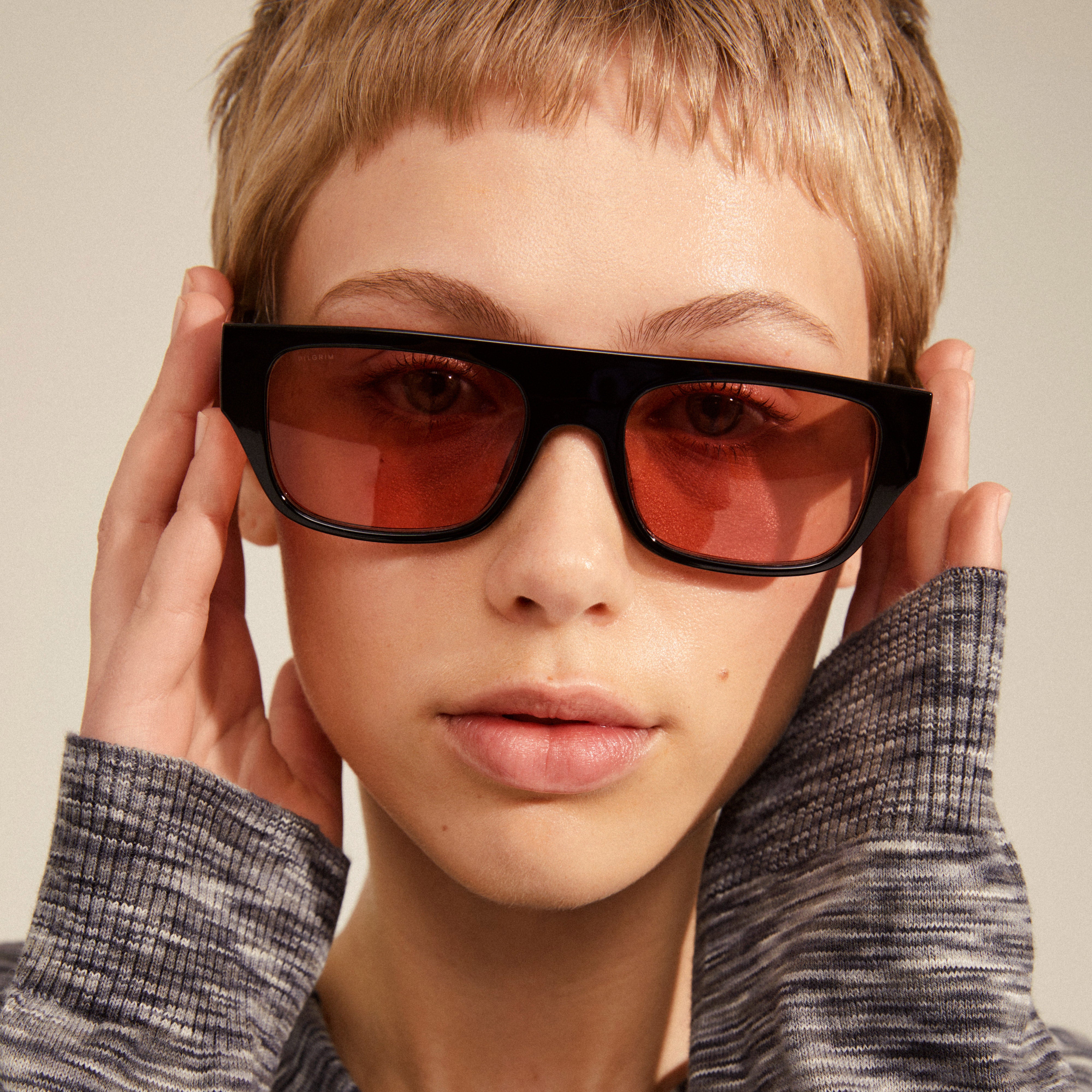ENIEL sunglasses feature black frames with golden accents and trendy orange lenses, offering a stylish, eco-friendly option with UV protection.