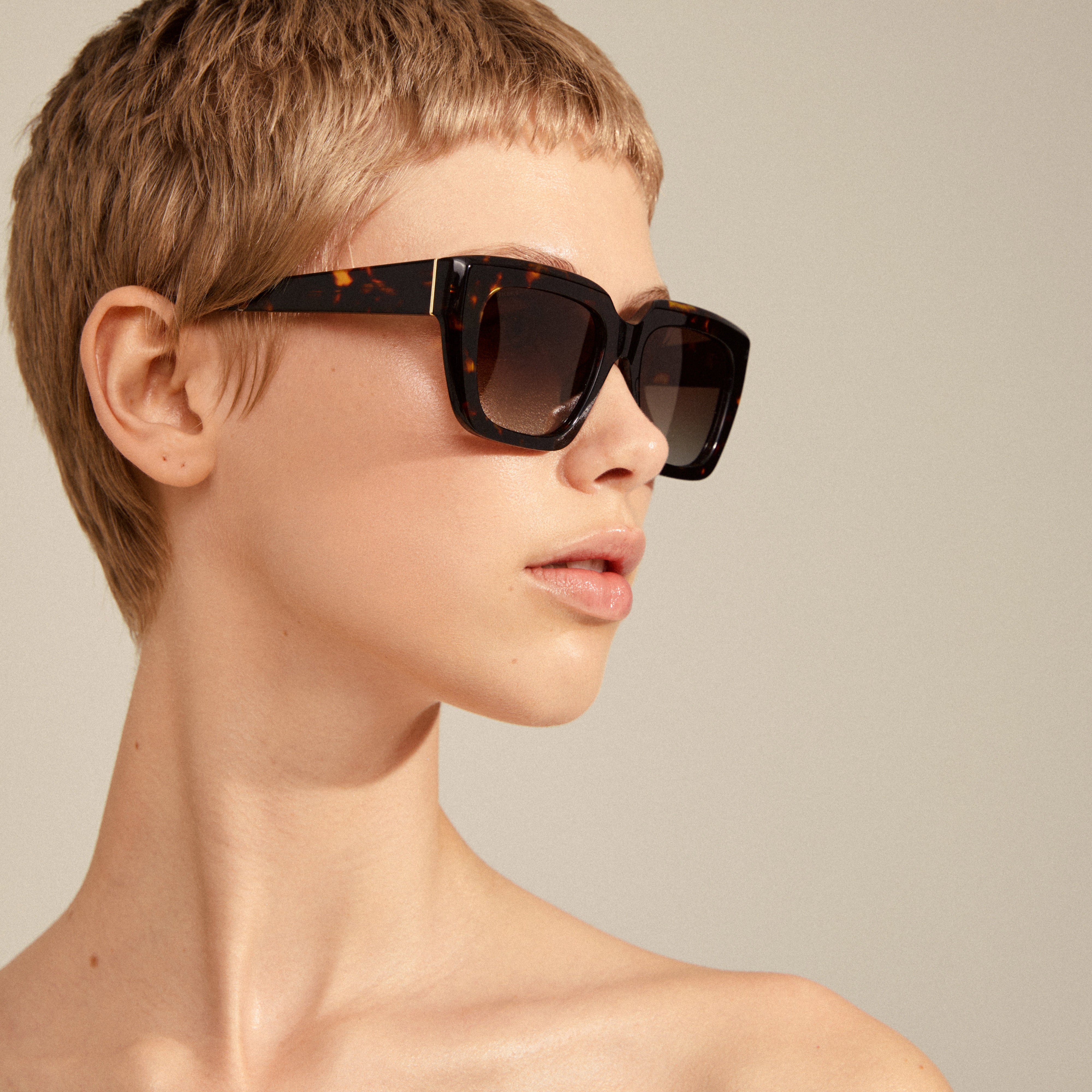 JOGLI sunglasses tortoise brown/gold feature oversized frames with golden hinges, offering UVA/UVB protection, crafted from recycled acetate, embodying Pilgrim's Scandinavian quality and style.