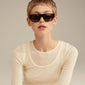 ENIEL sunglasses with tortoise-brown frames and dark lenses, worn by a woman. Features UVA/UVB protection and sustainable design by Pilgrim.