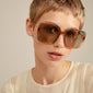 ALIET sunglasses multi/gold showcased on a woman with short hair, highlighting their oversized retro frames and golden temples, embodying a glamorous, vintage-inspired style.