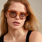 KYRIE sunglasses brown/gold worn by a woman, showcasing stylish eyewear with UVA/UVB protection, perfect for summer outings.
