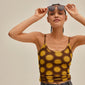 Woman smiling, wearing VANILLE sunglasses with sleek metal arms and a transparent brown frame, embodying minimalist style, ideal for summer accessorizing.