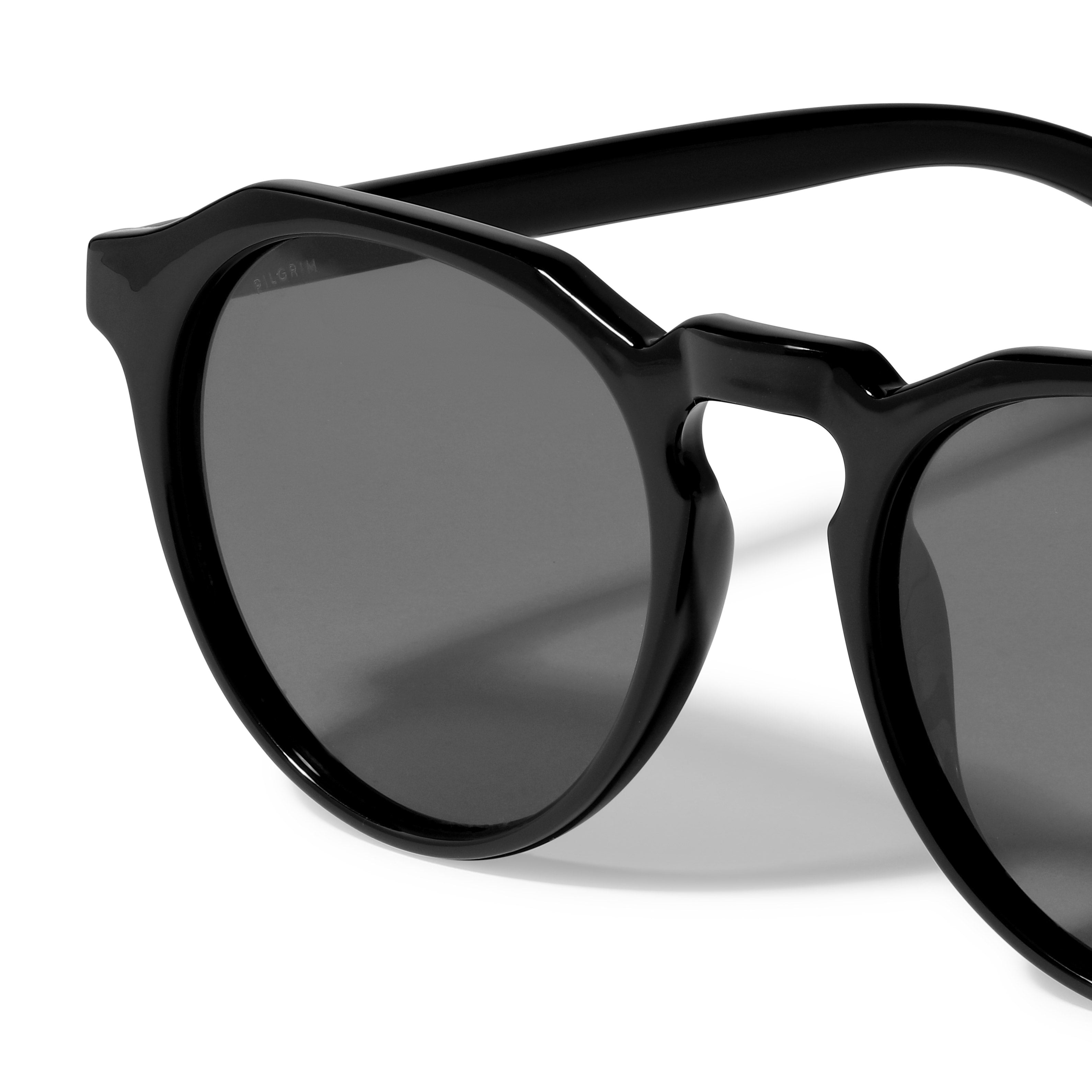 ALEJANDRA sunglasses black featuring a unique angular twist on classic round frames, offering UV protection, embodying Pilgrim's trendy, Scandinavian style.