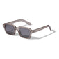 ANNALISE sunglasses by Pilgrim feature an angular, transparent frame with grey lenses, offering UVA/UVB protection. Made of 75% recycled plastic, perfect for versatile styling.