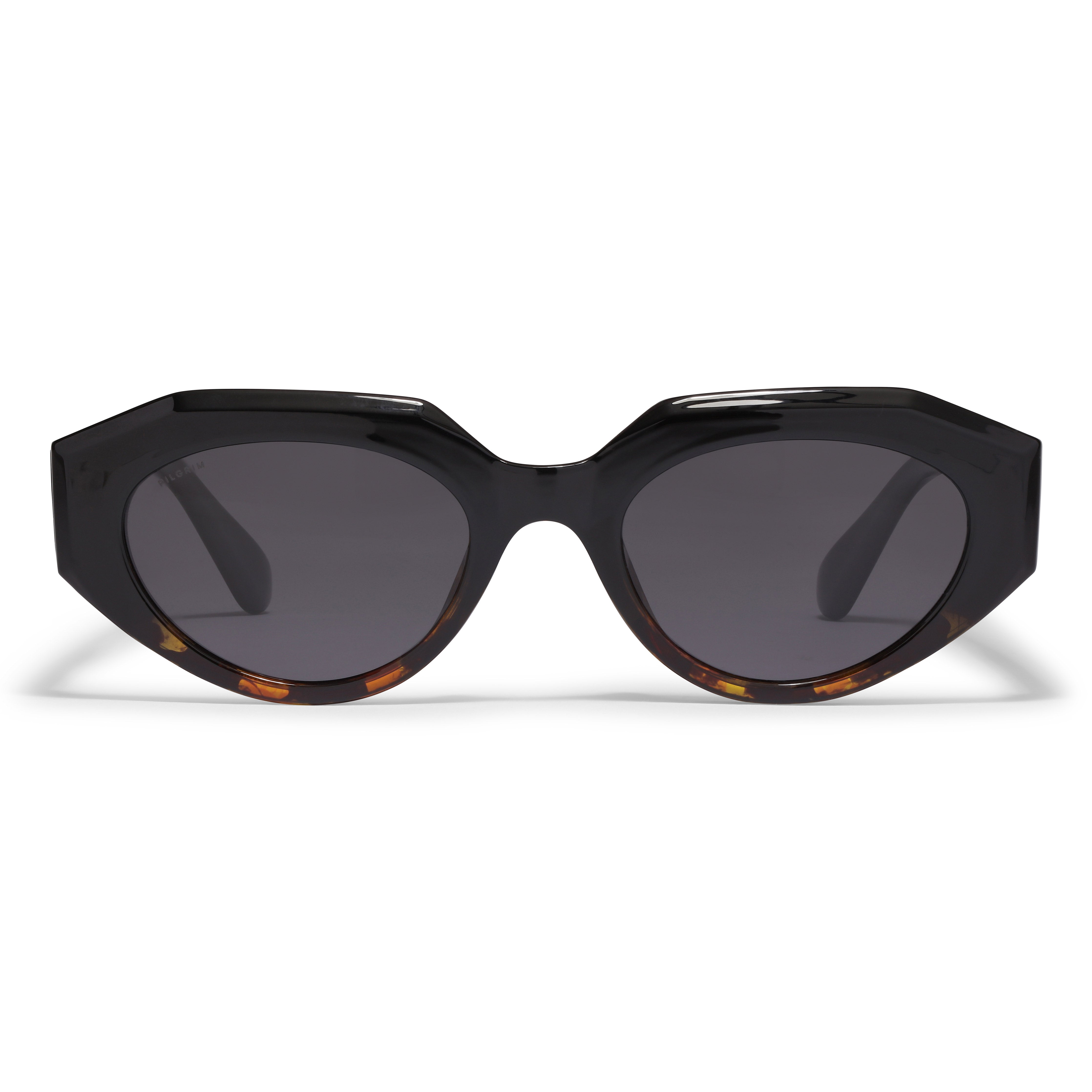 Close-up of ALEXIS sunglasses in tortoise brown featuring a chunky, futuristic design by Pilgrim, made from 75% recycled plastic with UV400 protection.