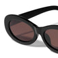 ALEXANDRIA sunglasses black with chunky eclipse-shaped frame and brown lenses, offering retro-inspired style and UV protection, made from 75% recycled plastic.