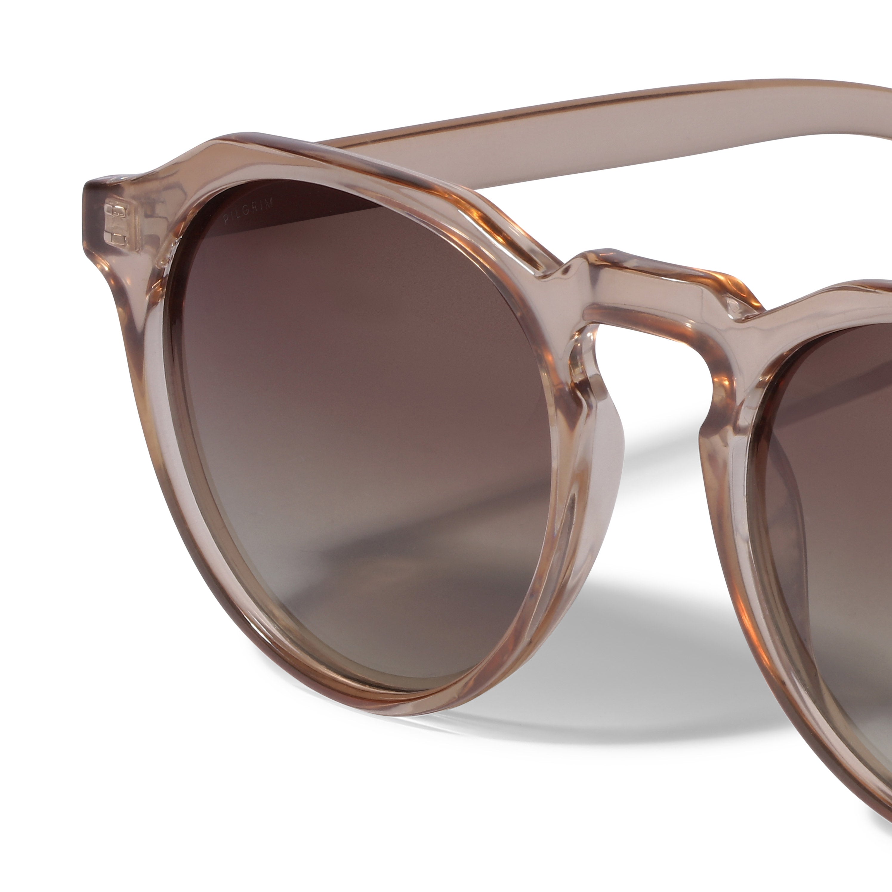 ALEJANDRA sunglasses in light brown with a unique angular twist on a classic round design, offering style and attitude. Comes with a dual-purpose fabric pouch.