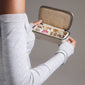 A person holds the Pilgrim Jewellery Box, Light Sand, Medium, showcasing its compact Scandinavian design for organizing rings, earrings, necklaces, and bracelets.