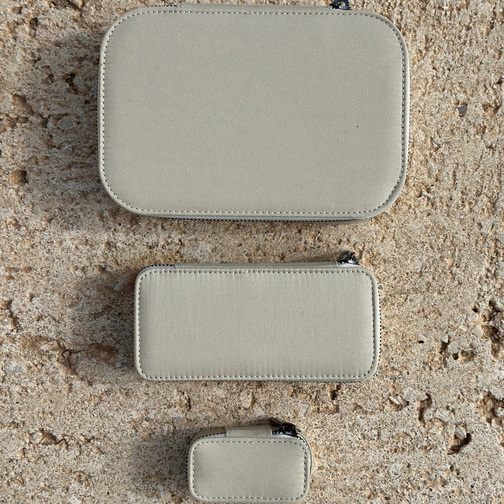 Close-up of a Pilgrim Jewellery box, Light Sand, Medium, showcasing its compact design with a sturdy zipper and organized compartments for rings, earrings, and necklaces.