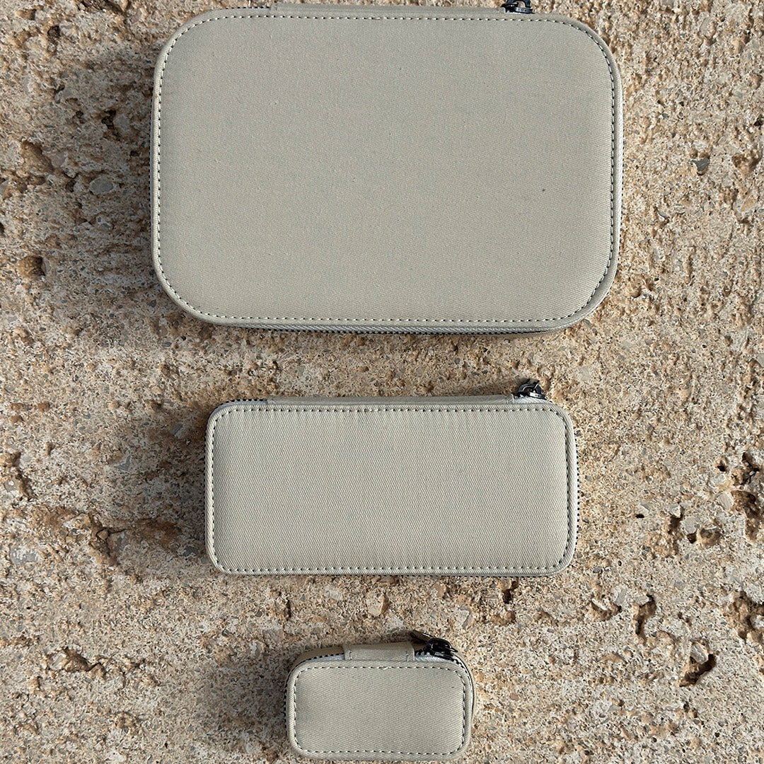 Close-up of the Jewelry Box, Light Sand, Large, showcasing its zipper and fabric texture, designed for organized jewelry storage with multiple compartments and secure closure.