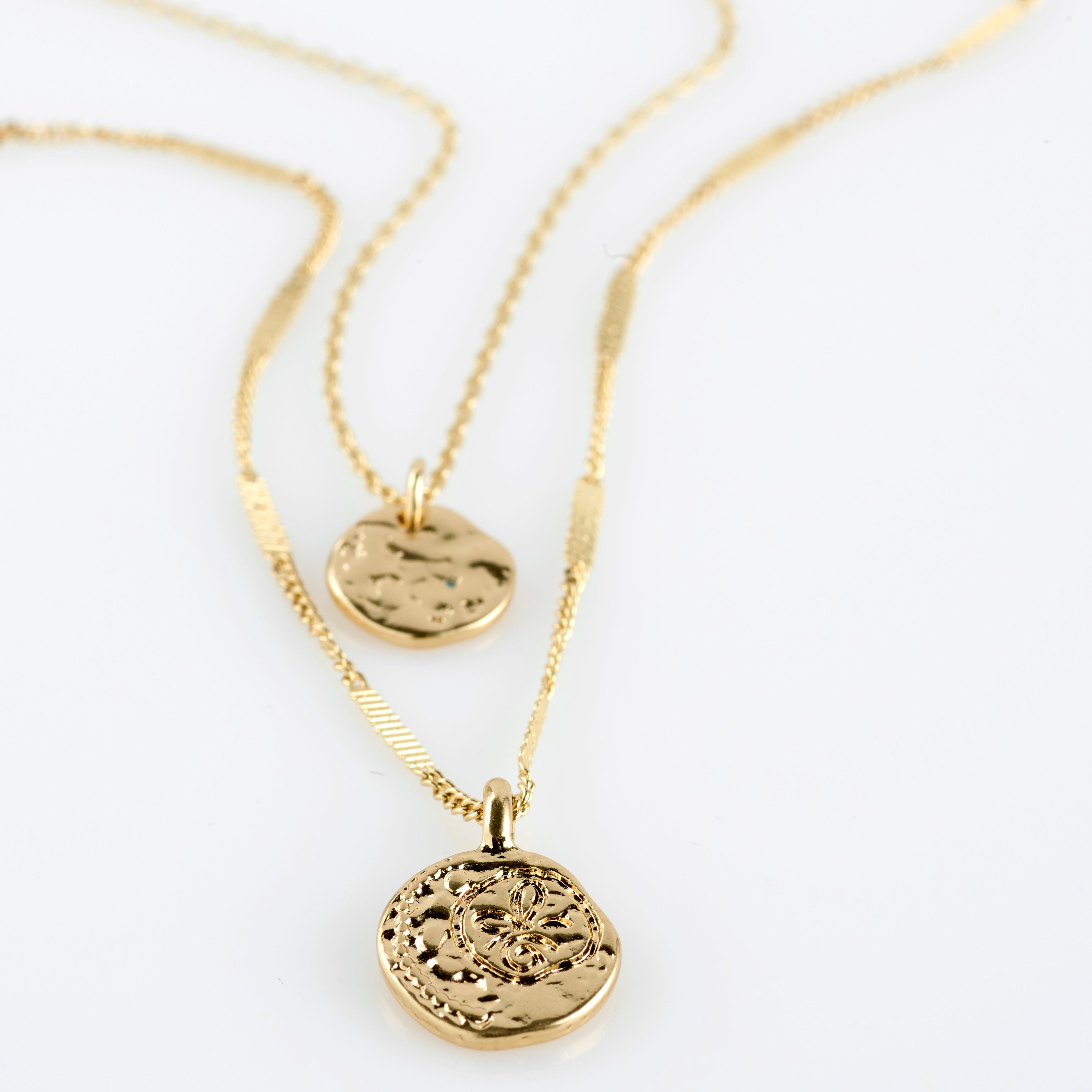 HAVEN 2-in-1 coin necklace gold-plated featuring two layered chains with hammered coin pendants, one with a floral motif, offering an elegant, bohemian style.