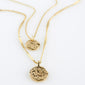 HAVEN 2-in-1 coin necklace gold-plated featuring two layered chains with hammered coin pendants, one with a floral motif, offering an elegant, bohemian style.