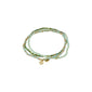 INDIGO 3-in-1 bracelet set, green/gold-plated, features soft green and neutral glass beads with gold-tone spacers and Pilgrim logo tags, offering versatile style options.