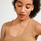 HARLAN gift set: close-up of a person wearing a gold-plated necklace with a crystal halo pendant and matching stud earrings. Elegant, eco-conscious jewelry from Pilgrim.