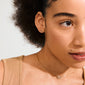 Young person wearing the HARLAN gift set: a gold-plated necklace with diamond-studded circles and matching stud earrings, embodying timeless elegance and Scandinavian craftsmanship.