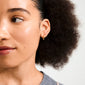 Young woman wearing HALO gift set earrings, showing a small stud and gold hoop on her earlobe, highlighting Pilgrim's blend of timeless and trendy jewellery.