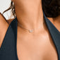 Close-up of HARLAN gift set: silver-plated necklace with interlocking ring pendant, featuring sparkling crystals, elegantly worn with a matching pair of stud earrings.