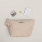 Limited Goodie Bag features twisted-gold hoop earrings, a fold-over mirror, and a PILGRIM canvas pouch—everyday essentials crafted from 99% recycled materials.